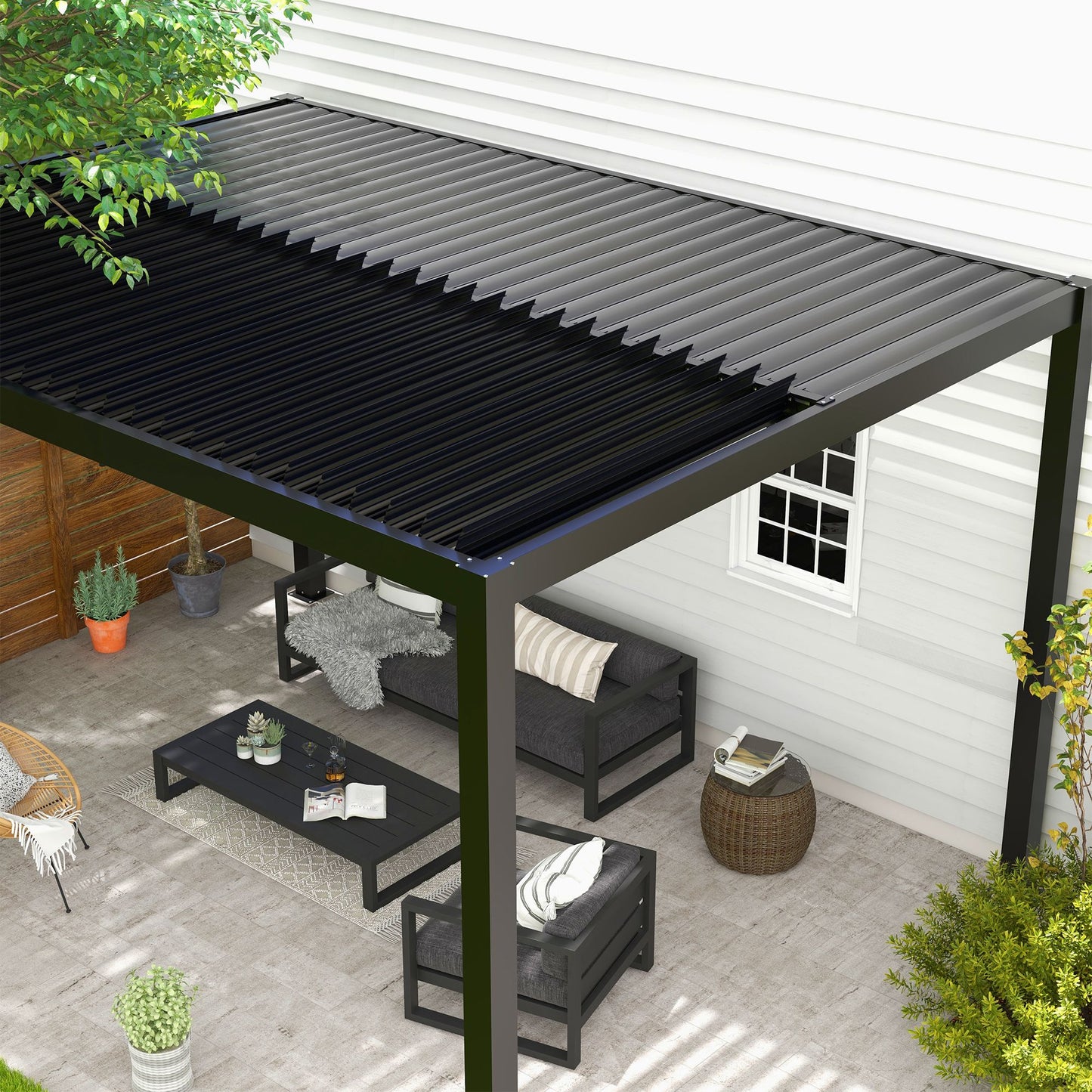 A sleek black pergola with integrated rainwater drainage system visible on one of its aluminum posts.